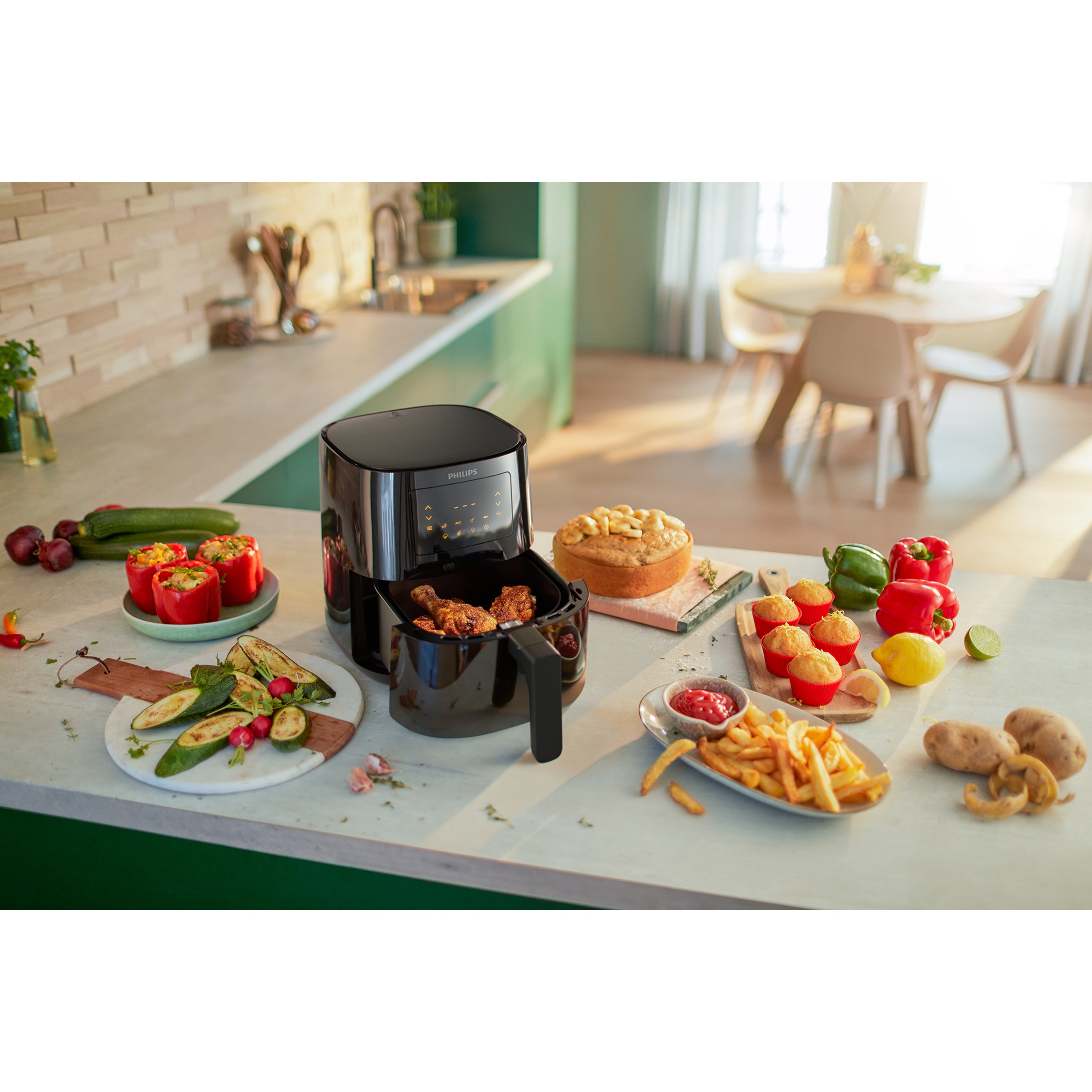 Black air fryer on a kitchen counter with various food items around it.
