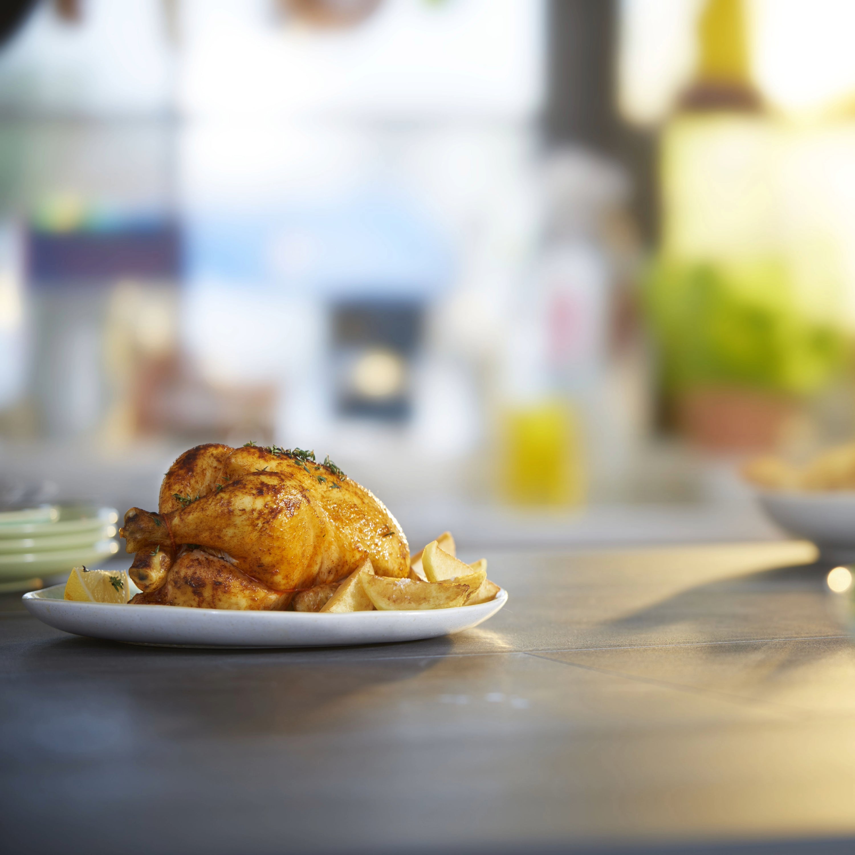 Roasted chicken with potatoes on a plate.