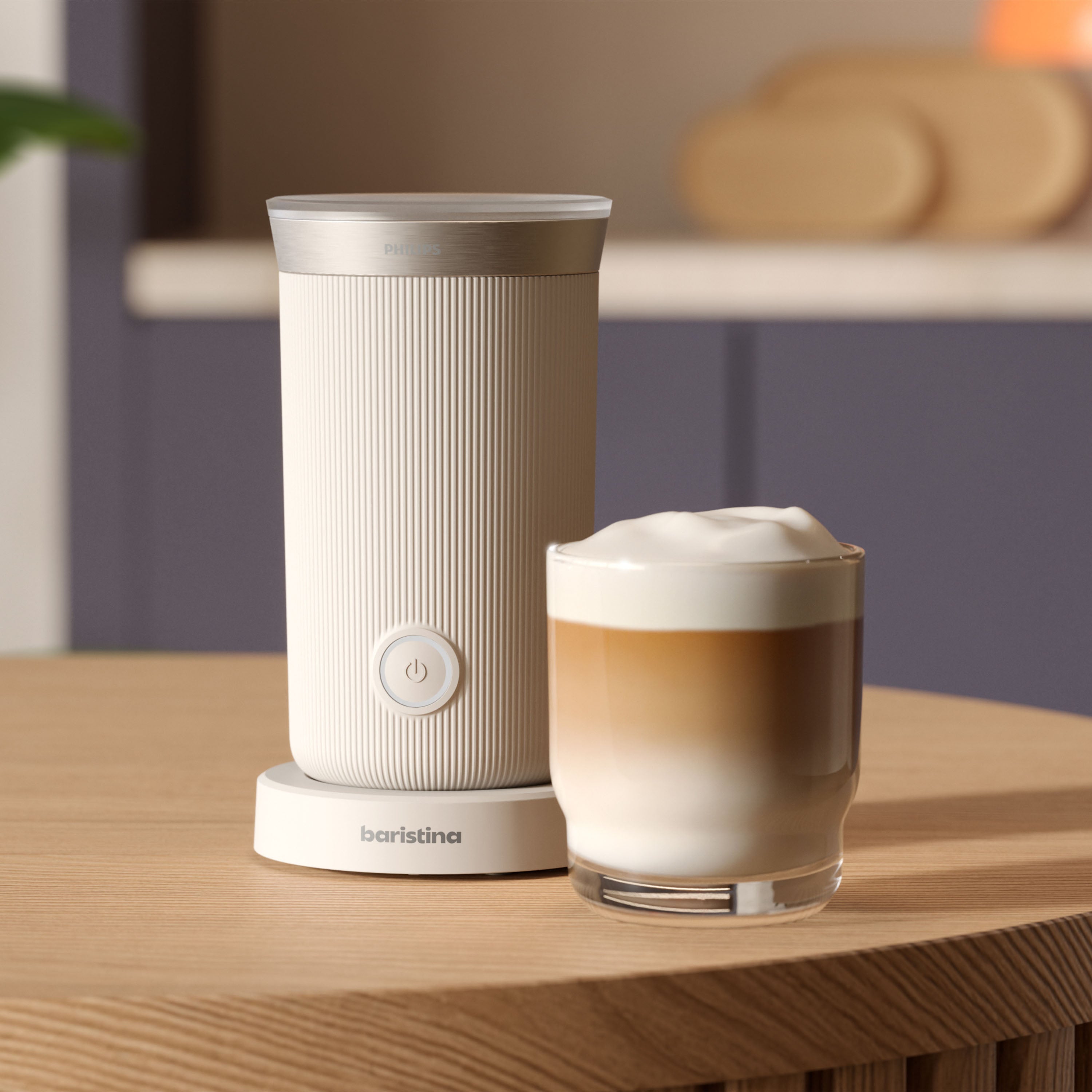 Philips Baristina milk frother makes cafe-style cappuccinos; lifestyle image shows frother and a glass of cappuccino.