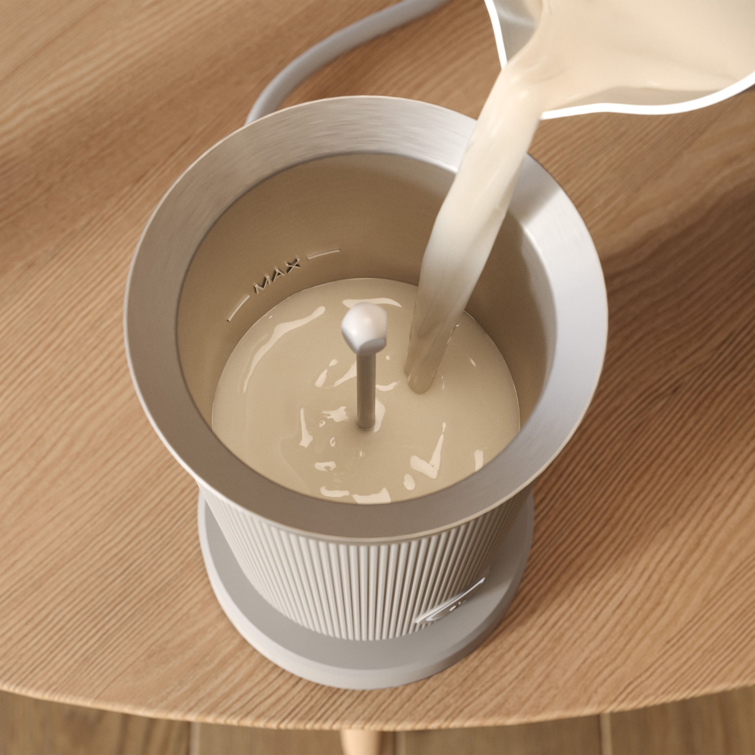 Milk being poured into a Philips milk frother.