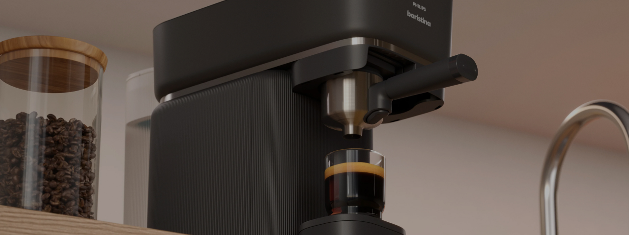 Philips Baristina espresso machine making espresso in a glass.