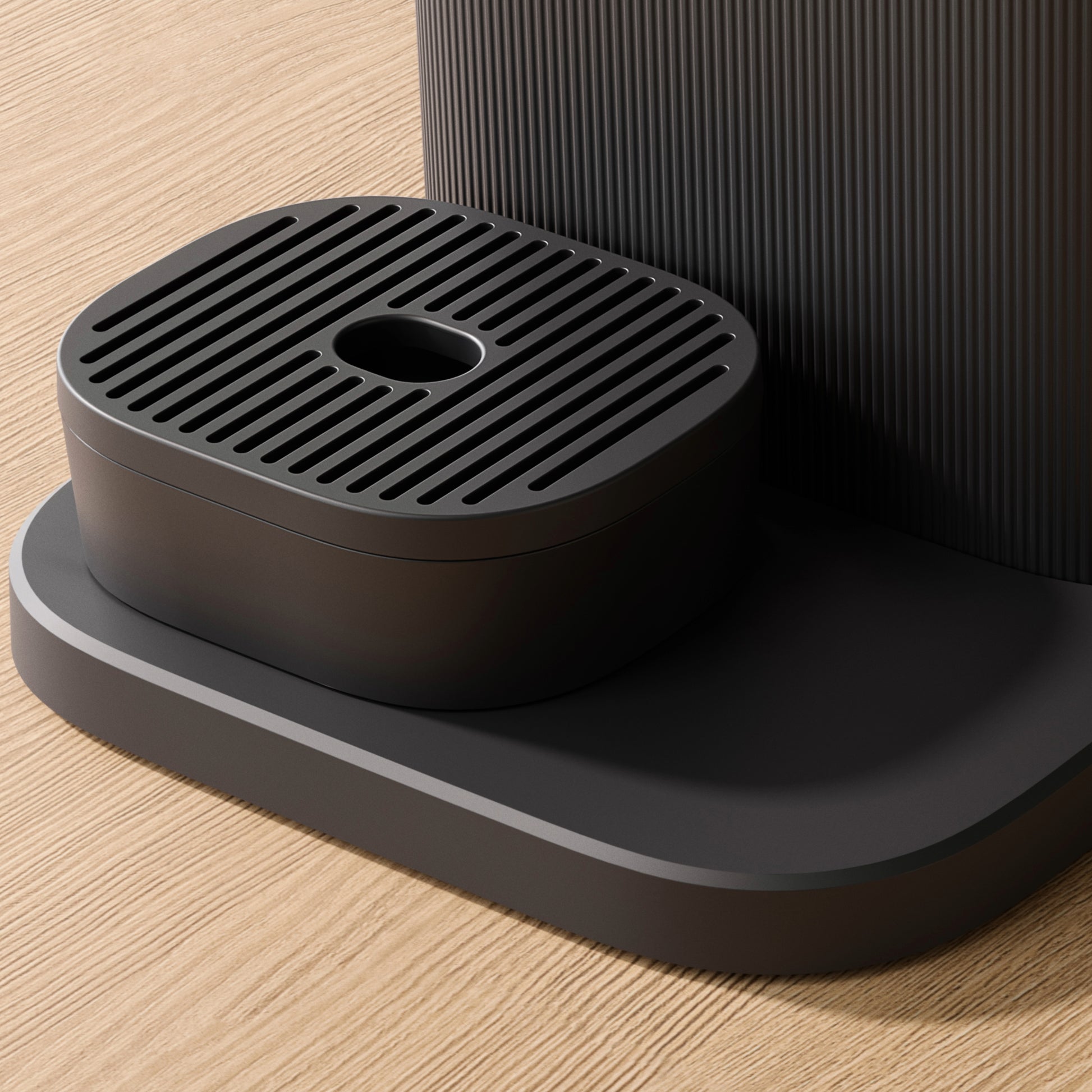Close-up of the Philips Baristina coffee machine's black drip tray.