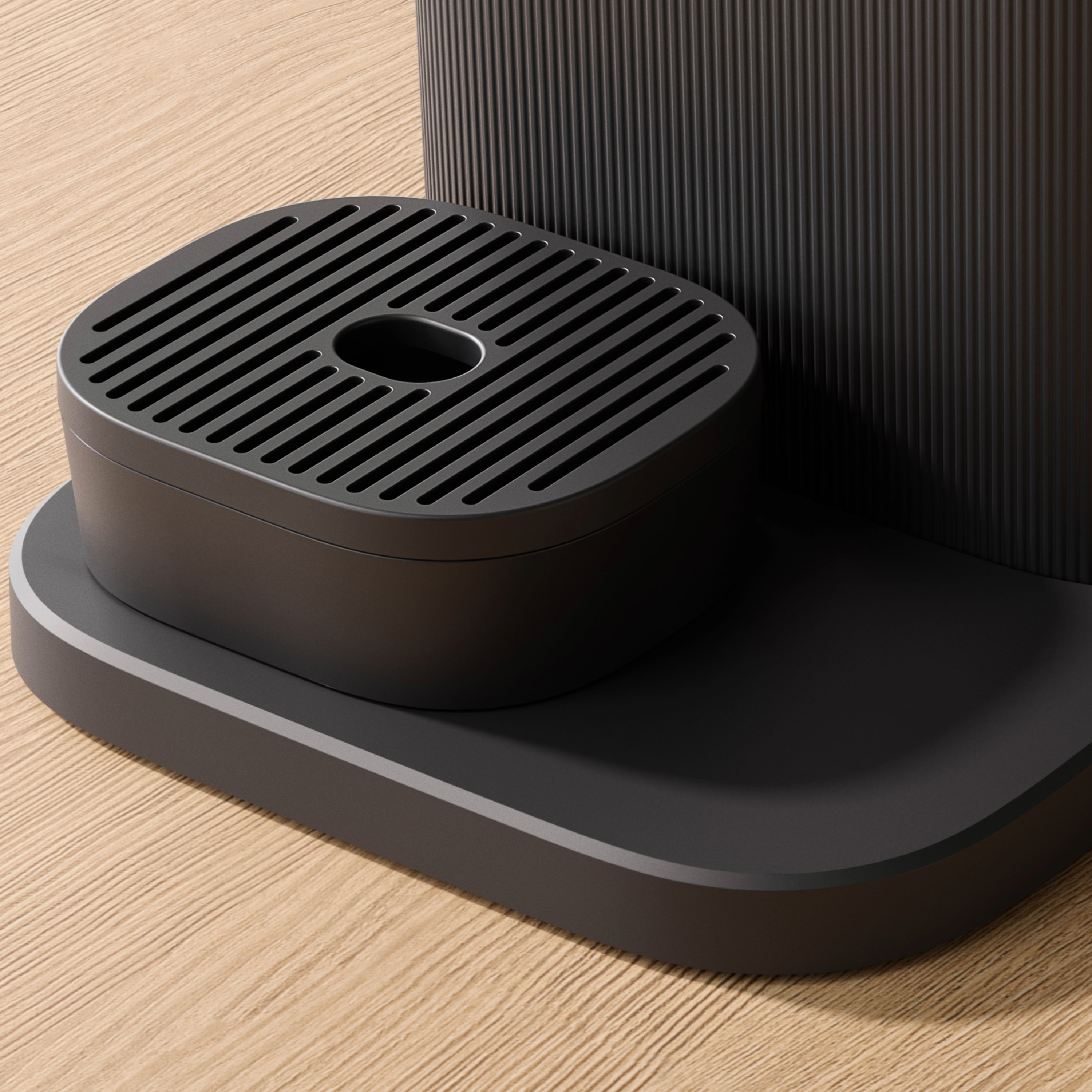 Close-up of the Philips Baristina coffee machine's black drip tray.