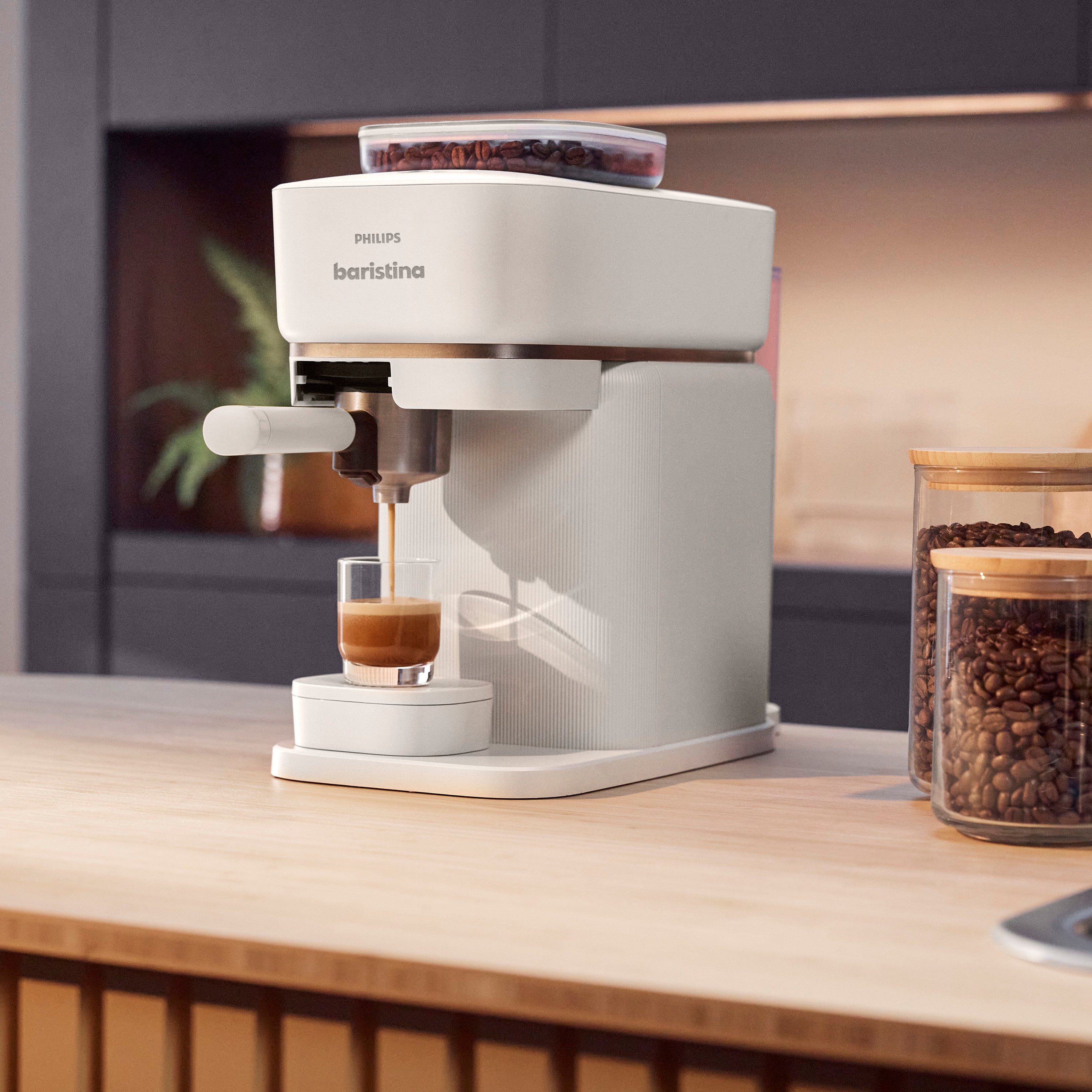Philips Baristina espresso machine making espresso in a glass.