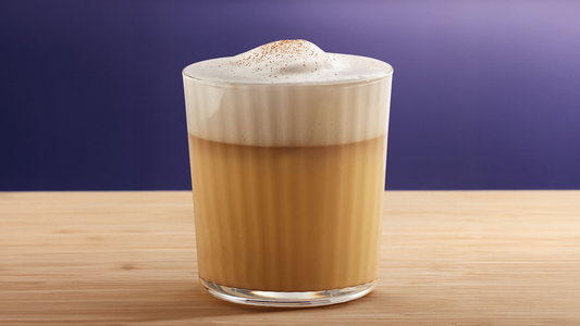 Showing a coffee with froth on top.