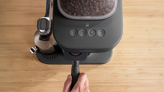 Showing the top of the Baristina Latte with hand on portafilter handle