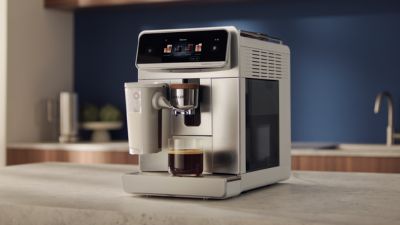 Philps 8000 Series Coffee Machine sitting on a countertop making a coffee.