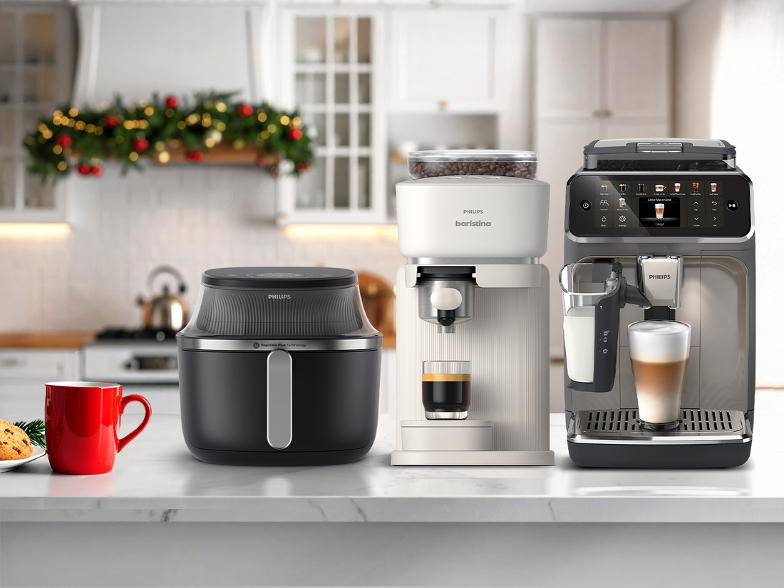 Philips kitchen appliances including a coffee maker, air fryer, and espresso machine on a kitchen counter.