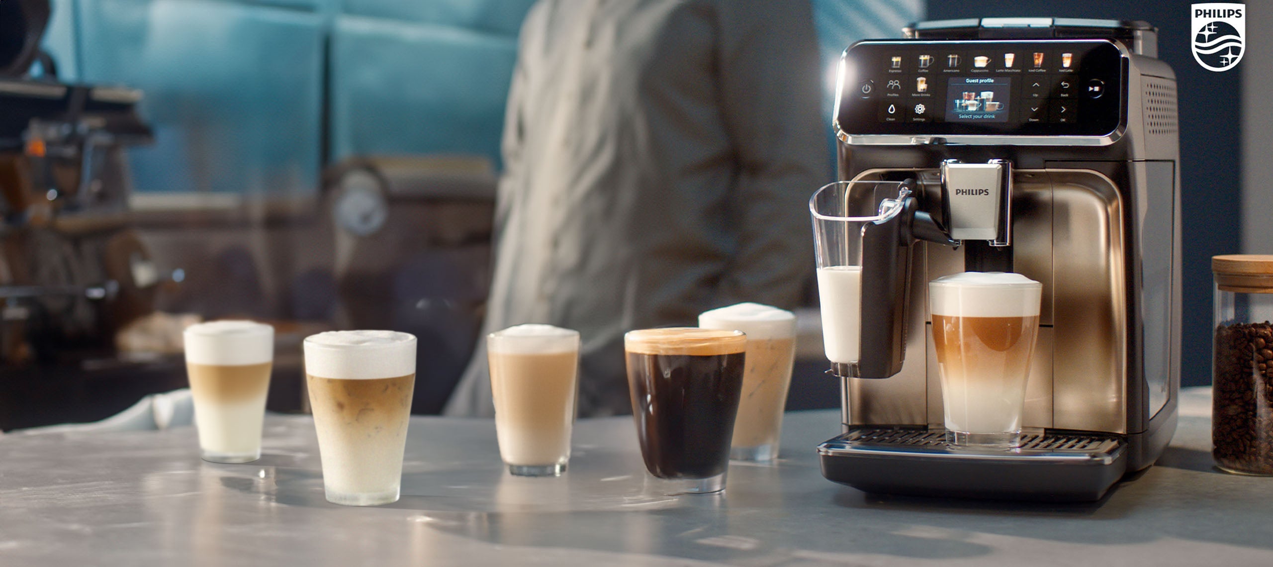 Coffee machine with various coffee drinks displayed in front of it