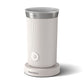 Philips Baristina milk frother: Close-up of a white, ribbed appliance with a silver top and a power button.