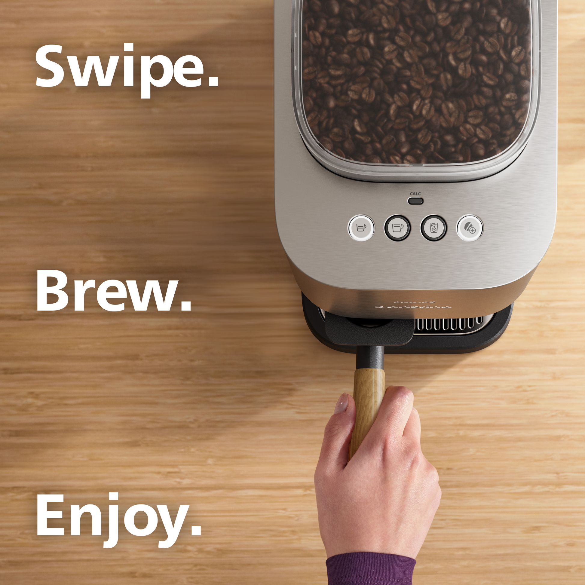 Coffee brewing device with coffee beans, hand using a scoop, and text 'Swipe. Brew. Enjoy.' on a wooden surface.