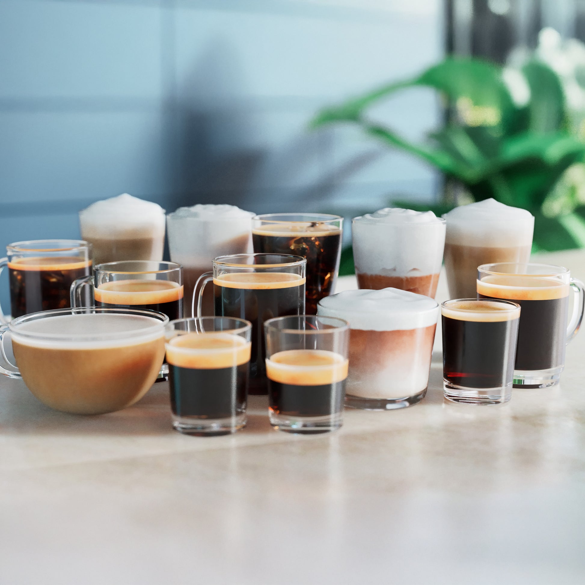 Various coffee drinks in glasses on a light surface with a blurred background