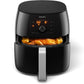 Black Philips air fryer with chicken inside on a white background