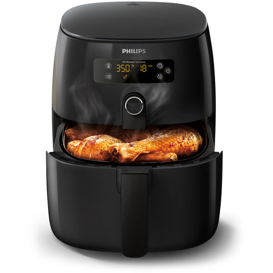 Philips air fryer with chicken inside on a white background