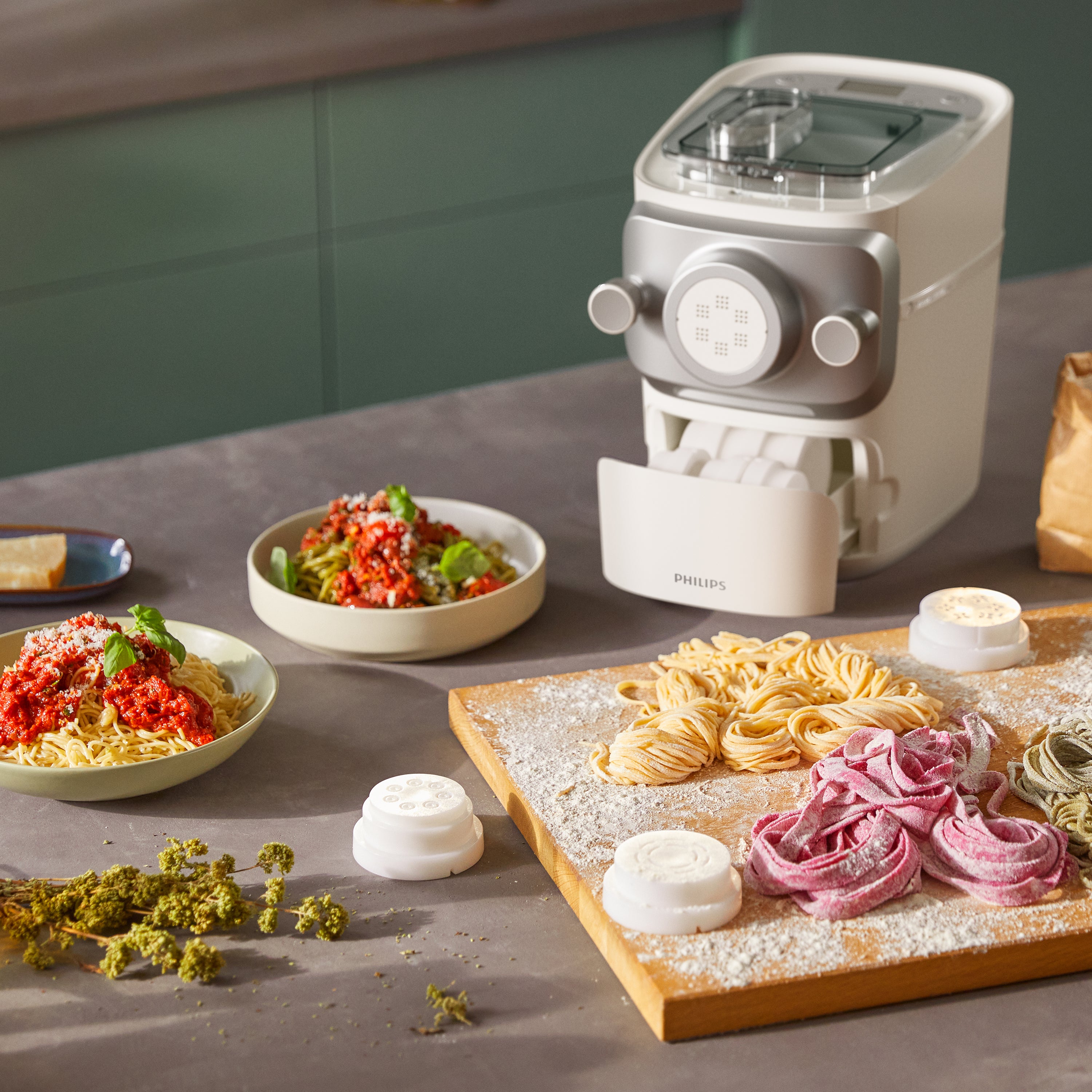 Philips pasta maker with various pasta shapes on a kitchen counter