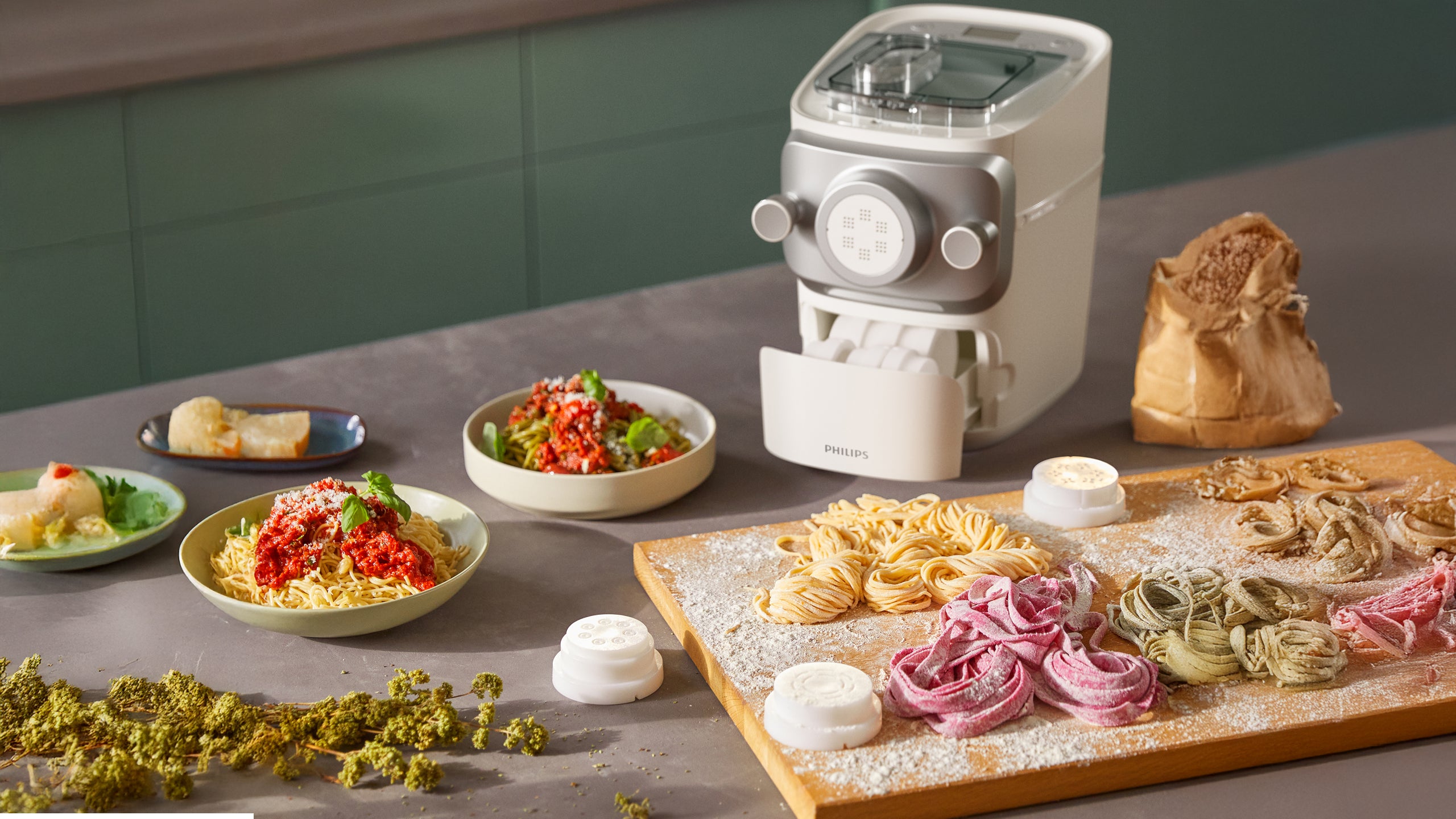 Pasta maker with various pasta types on a table