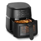 Philips air fryer with food inside on a white background