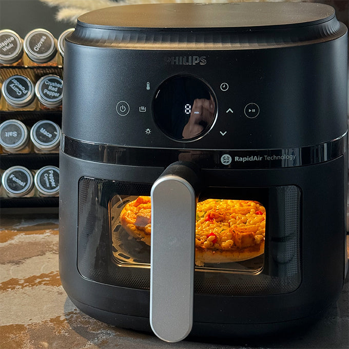 Philips airfryer with window cooking a pizza