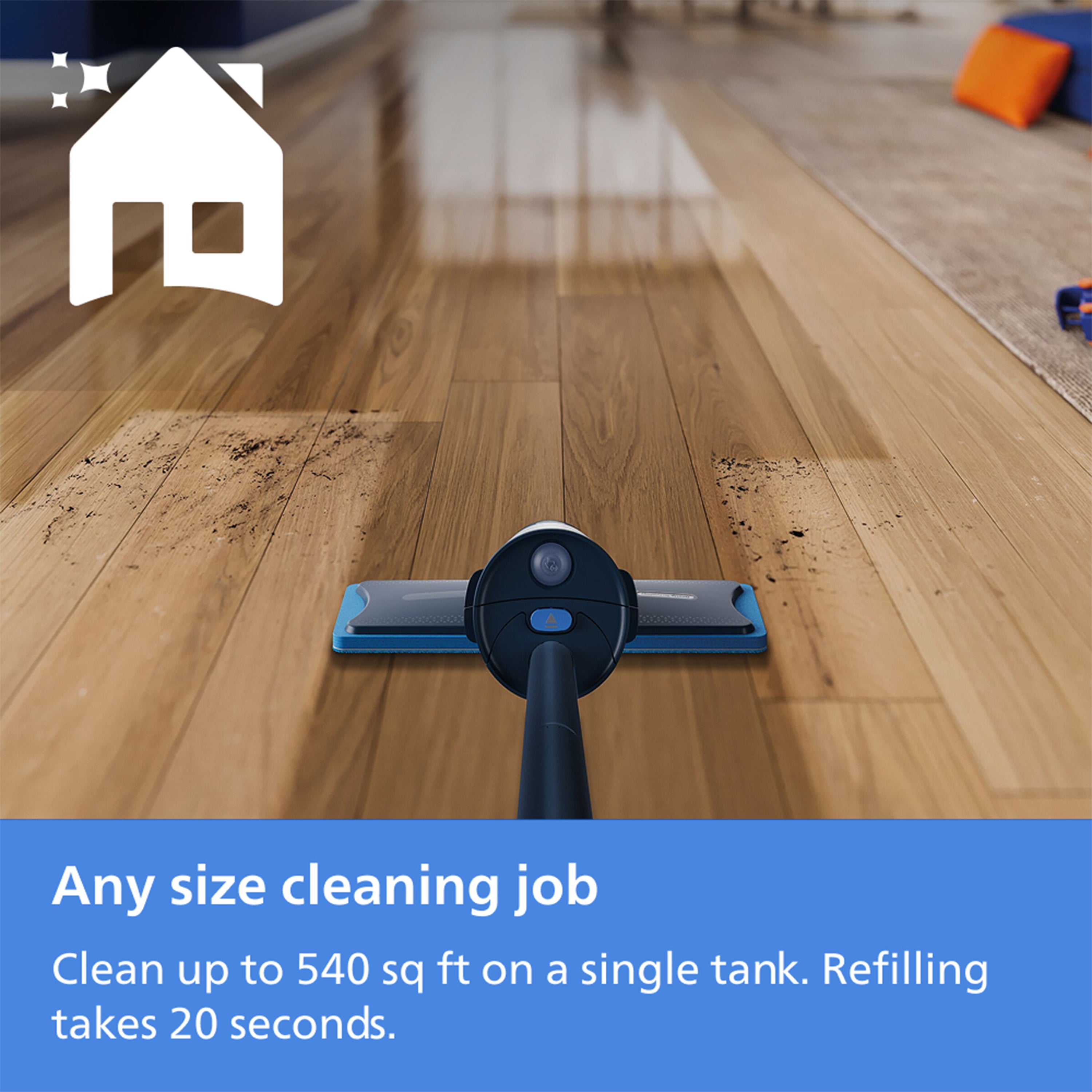 A cordless floor cleaner head shown from above on a hardwood floor, with a white house icon in the top left and a blue text banner at the bottom reading 'Any size cleaning job Clean up to 540 sq ft on a single tank. Refilling takes 20 seconds.