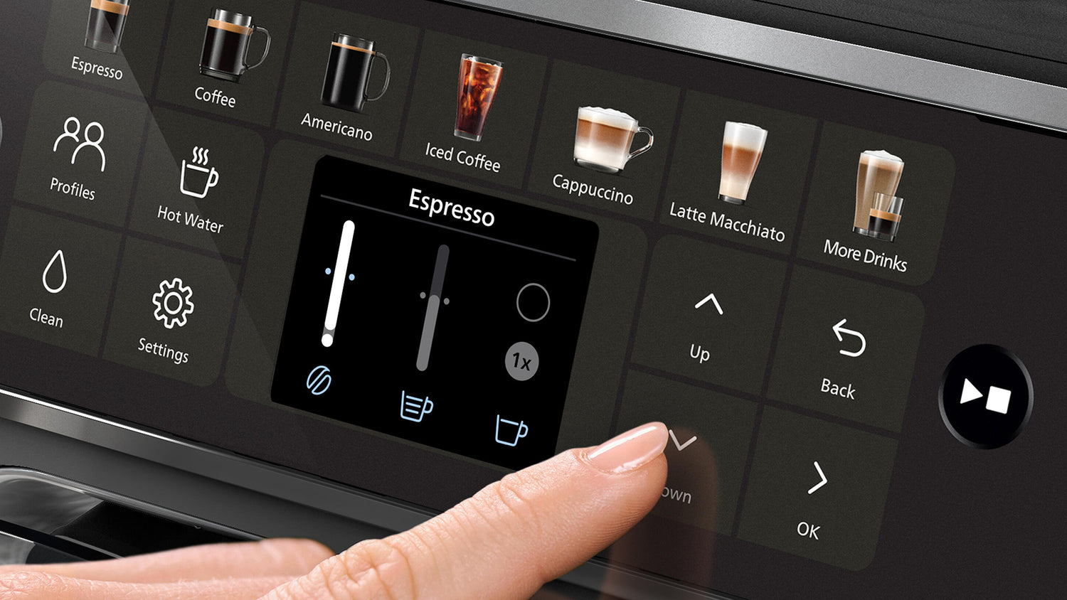 Coffee machine control panel with espresso selection and a finger pressing an option.